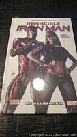 Front cover of sealed Iron Man graphic novel showing Iron Man and a female character with title 'Invincible Iron Man: The War Machines'.