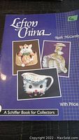 Front cover of the Lefton China Price Guide reference book showing images of three Lefton China pieces: a cat figurine in a basket, a cat-shaped creamer jug, and a figurine of a woman in bonnet.