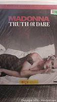 Front cover of the Madonna Truth or Dare widescreen edition LaserDisc showing Madonna lying on a bed wearing black.