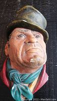 Close-up front view of the vintage Bossons head sculpture showing detailed painted texture and expression of the man wearing hat and scarf.