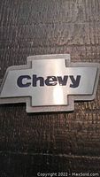 Close-up photo of the front of the metal Chevy belt buckle showing the logo and text.