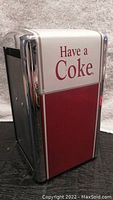 Front and side view showing the 'Have a Coke' text on the red and white panel with chrome edges.
