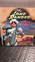 Front cover of vintage children's book The Lone Ranger Desert Storm showing Lone Ranger on horse with sunset background, some creasing and wear visible