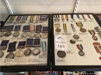 Two black-framed medal displays side by side showing rows of British and international medals