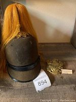 Overall view of helmet with plume, eagle plate and brass insignias