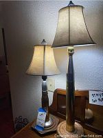 Two table lamps side by side on wooden surface, showing overall height and shades