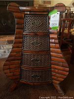 Full front view of the bamboo chest showing curved sides and four drawers