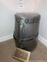 Full front view of the helmet showing overall shape, riveted construction and lot placard