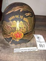 Front view of helmet with insignia and cover