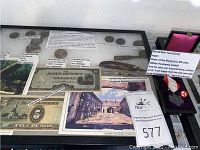 Overview of entire lot including medal, cup, tags, insignia, currency, photo and steel fragment.