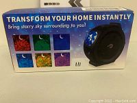 Box front showing the LED projector light and different available color effects for the starry sky projection.