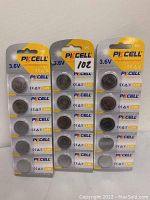 Photo showing three separate packs of PkCell LIR2025 3.6V rechargeable lithium-ion button cell batteries in original unopened blister packaging on branded yellow and white backing cards.