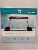 Front of box showing BeAutural digital bathroom scale with a glass platform and LCD screen showing weight 120.0.