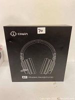 Front of the closed black box showing Cowin branding and 'E7 Wireless Headphones'.