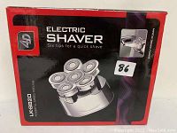 Front view of the packaging showing the Electric Shaver LK-8820 with six rotary tips and slogan 'Six tips for a quick shave'
