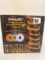 Box front showing brand Image, product name Waterproof Outdoor Rope Lights, and image of rope lights wrapped around a post.