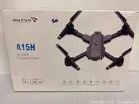 Photo of the front of the Snaptain A15H 4-axis foldable drone box showing the drone image and product name