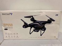 Box front of Snaptain SP650 4-Axis Drone showing image of drone and model number