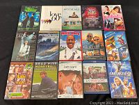 Photo showing 15 DVD cases including Street Fighter, Love 60's, Into the Wild, College Road Trip, Julie & Julia, Michael Jackson This Is It, Poseidon, Meet Dave, The Bucket List, Finding Nemo 2 pack, Burn After Reading, Moneyball, I Am Sam, Eat Pray Love, Fantastic 4: Rise of the Silver Surfer.