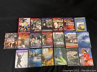 Full display of all 22 DVDs laid out on black cloth, showing titles and cover art from Charlie Chaplin films, nature documentaries, and historical films.