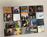 Photo showing 20 CDs including Queen, Bee Gees, Ozzy Osbourne, Vanessa Paradis, Scorpions, Genesis, and others.