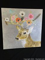 Front view of the square canvas painting of a deer with floral and feather details on antlers.