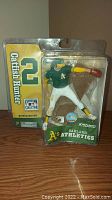 Figure in original plastic packaging with Catfish Hunter name and number 2 on left, Oakland Athletics branding below, and McFarlane's Sports Picks branding in front.