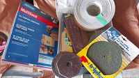 Various sandpapers including Norton MultiSand sheets, sanding rolls, flap wheel, and discs assembled on a surface