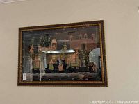 Framed Indian batik wall decor showing a traditional scene with figures, elephant and palace backdrop.