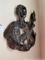 Front view of the full sculpture mounted on wall