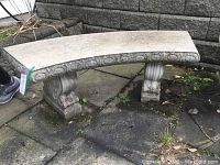 Curved side view showing molded oval pattern along bench skirt and one pedestal support.