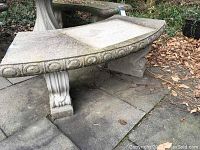 Angled view of full bench on stone patio with fallen leaves