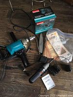 Makita BO5030 random orbit sander box, small drill/screwdriver, chuck key, triangular pad, bagged sandpaper