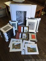 Overview of all frames and prints arranged on floor and table