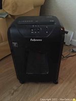 Front view of Fellowes 60MC paper shredder showing brand name and waste bin window