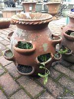 Front view of planter showing multiple side planting pockets and top rim