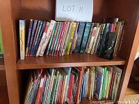 Shelf with approx. 30+ worn children's books of various titles and sizes