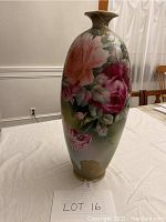 Full view of the tall oval decorative vase showing the front floral design with large pink flowers and gold accents