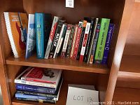 Photo showing a shelf with college textbooks including Thinking Like an Engineer, Microeconomics, Probability and Statistics, Oceanography, and others.