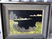 Front view of framed landscape artwork with visible texture and layered cutout elements on black background