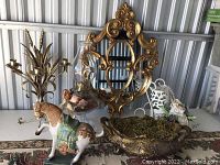 Photo showing all decorative items arranged together on a table in storage unit.