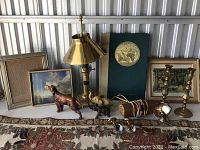 Wide view of all items showing framed art, lamps, figurines, and candlesticks on tabletop