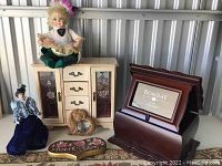All items displayed together on a surface including the two dolls, jewelry box, Bombay photo frame, teddy bear photo frame, and Welcome Room plaque