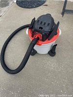 Full view of Rigid wet/dry vacuum showing hose and tank