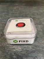 FIXD automotive diagnostic device in plastic case with displayed logo and instruction card.