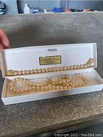 Full view of Nolan Miller simulated pearl bracelet and necklace set in original box