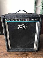 Front view of Peavey Minx 110 amplifier showing the control panel, speaker grille, and logo.