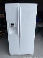 Full front view of white Samsung side-by-side refrigerator with ice and water dispenser on freezer door.