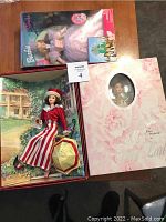 Three boxed Barbie dolls: Glinda, Coca Cola, and My Fair Lady. Show some box wear.