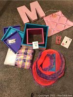 Full lot of wall and room decor items arranged on a carpeted floor, showing all shelves, wall decor, letter 'M', light switch covers, bed ruffle and hanging storage